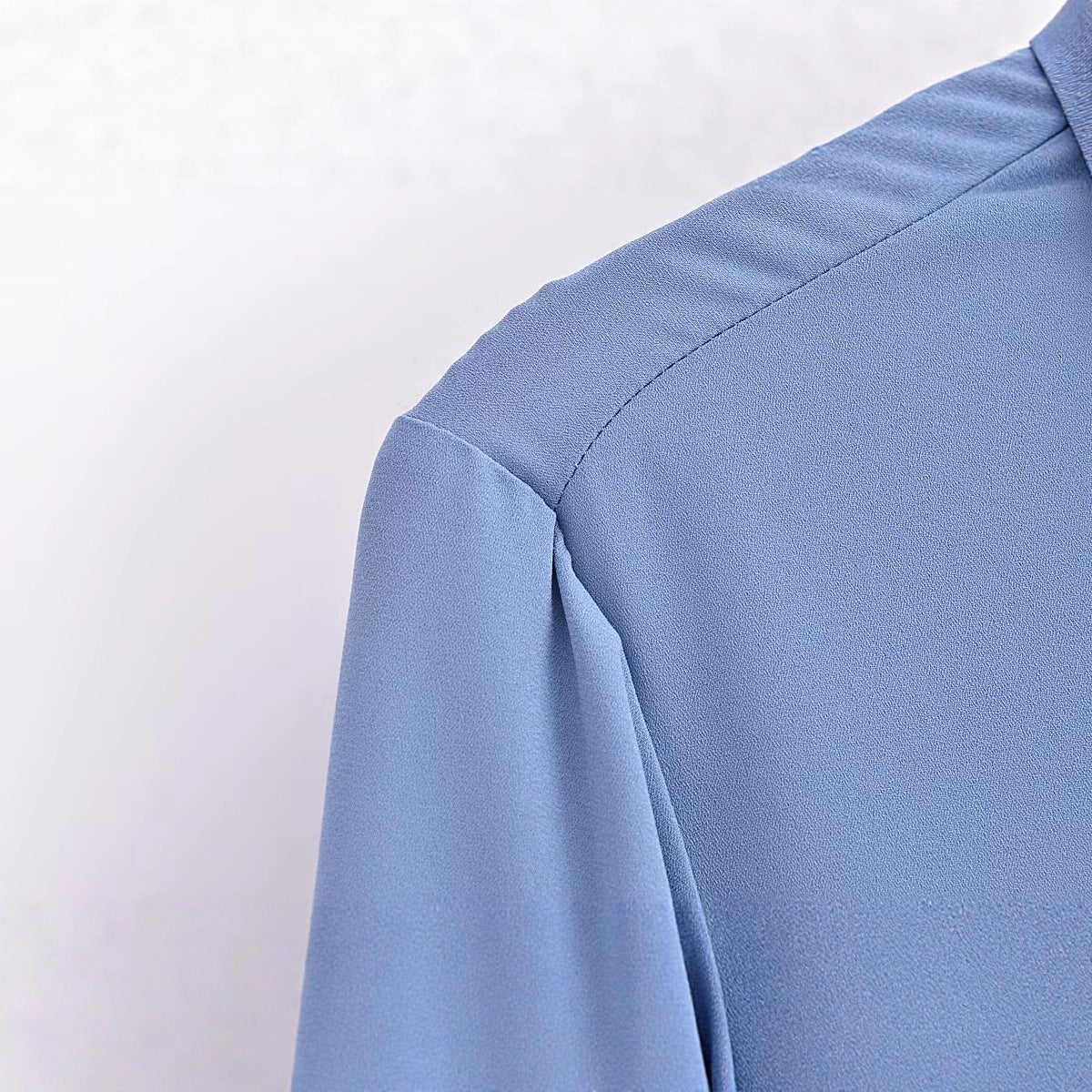 Long sleeved blue pocket embellished crepe shirt